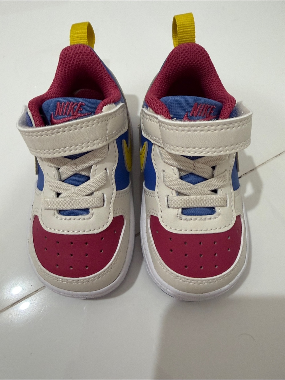 Nike Kids White Sneakers with Pink, Blue & Yellow Accents